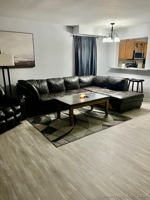 6 Hakim St Unit 2-6, Danbury, CT 06810 - living area featuring light wood-style flooring and a chandelier