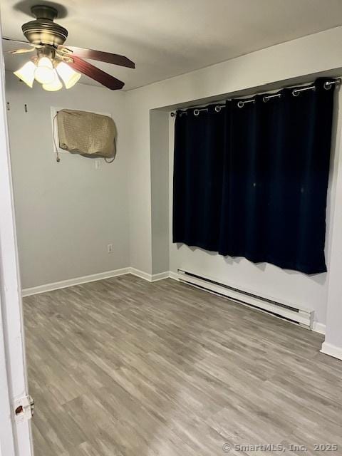 6 Hakim St Unit 2-6, Danbury, CT 06810 - spare room featuring a baseboard radiator, baseboards, light wood finished floors, and a ceiling fan