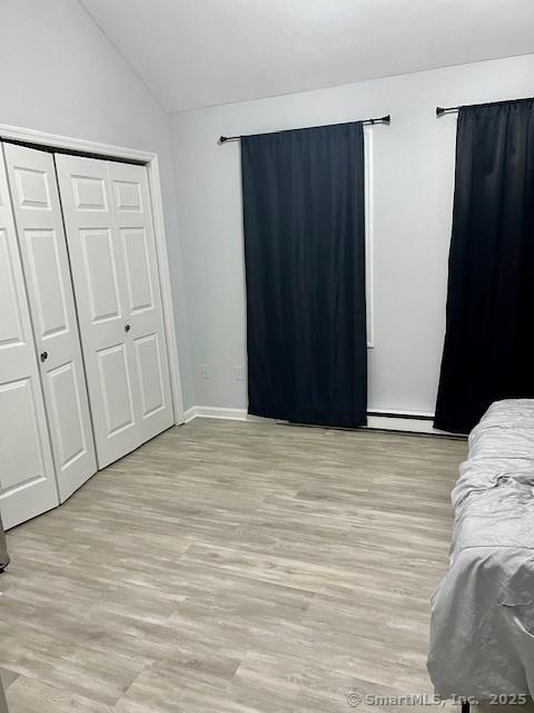 6 Hakim St Unit 2-6, Danbury, CT 06810 - bedroom with light wood-style floors, vaulted ceiling, a closet, and baseboards