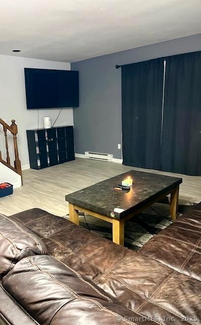 6 Hakim St Unit 2-6, Danbury, CT 06810 - living room featuring a baseboard radiator, baseboards, stairs, and wood finished floors