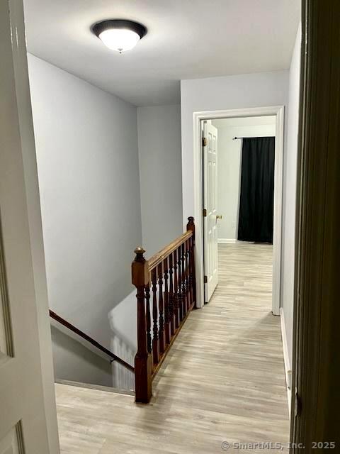 6 Hakim St Unit 2-6, Danbury, CT 06810 - hallway featuring an upstairs landing, light wood finished floors, and baseboards