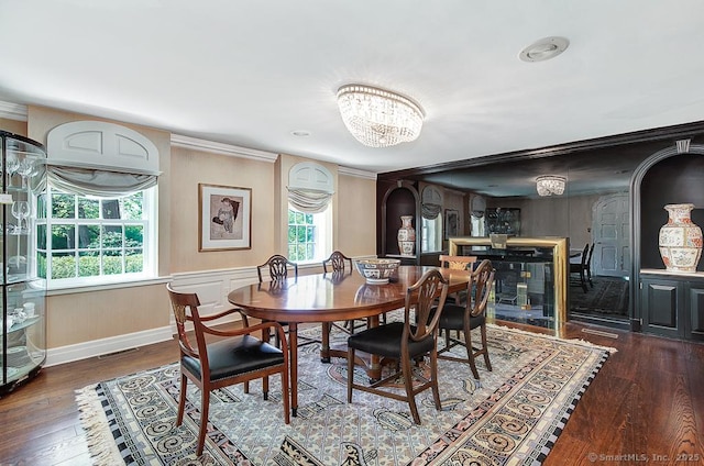 37 Hunting Hill Rd, Woodbridge, CT 06525 - dining space with a chandelier, wood finished floors, arched walkways, and ornamental molding