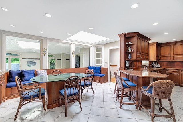 37 Hunting Hill Rd, Woodbridge, CT 06525 - kitchen featuring a kitchen breakfast bar, a sink, light tile patterned floors, dark stone counters, and open shelves