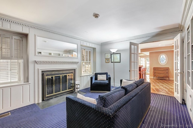 37 Hunting Hill Rd, Woodbridge, CT 06525 - living area with ornamental molding, a glass covered fireplace, baseboards, a decorative wall, and french doors