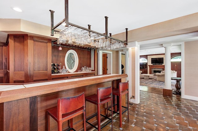 37 Hunting Hill Rd, Woodbridge, CT 06525 - indoor dry bar featuring a fireplace, recessed lighting, baseboards, and decorative columns