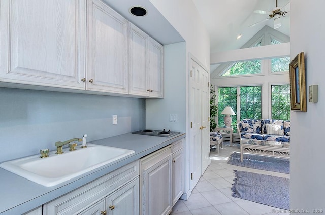 37 Hunting Hill Rd, Woodbridge, CT 06525 - kitchen featuring a sink, light countertops, light tile patterned floors, white cabinets, and high vaulted ceiling