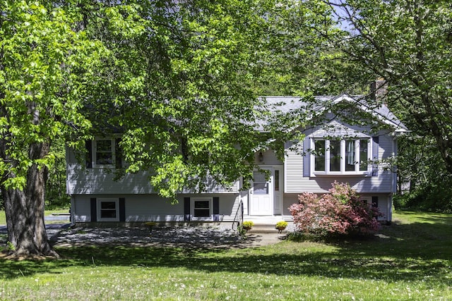 bi-level home with a front lawn