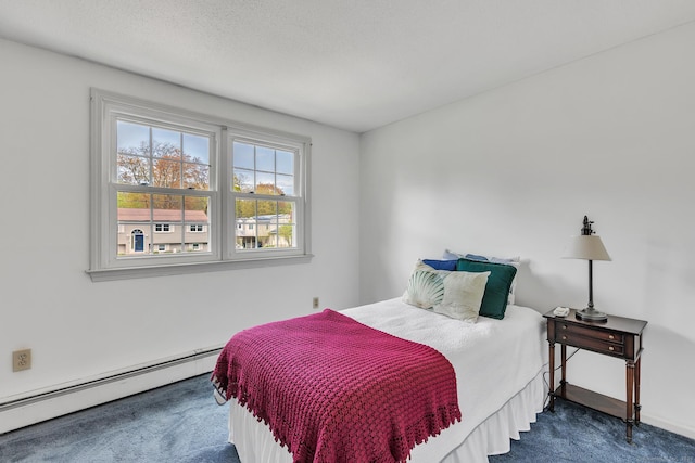 bedroom with a baseboard heating unit and carpet flooring