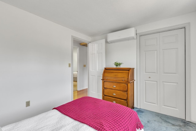 bedroom with an AC wall unit, a closet, and light colored carpet