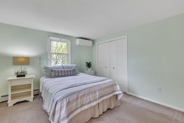 carpeted bedroom featuring an AC wall unit, a closet, a baseboard radiator, and baseboards