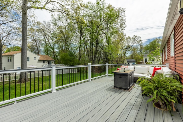 deck with a lawn, an outdoor hangout area, an outbuilding, and a storage unit