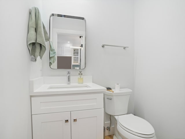 bathroom featuring toilet and vanity