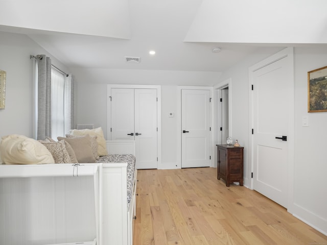 bedroom with light wood-style floors, recessed lighting, multiple closets, and baseboards