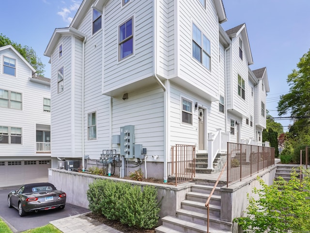 1 Howard Ave Unit B1, Norwalk, CT 06855 - back of house featuring a garage, central air condition unit, and driveway