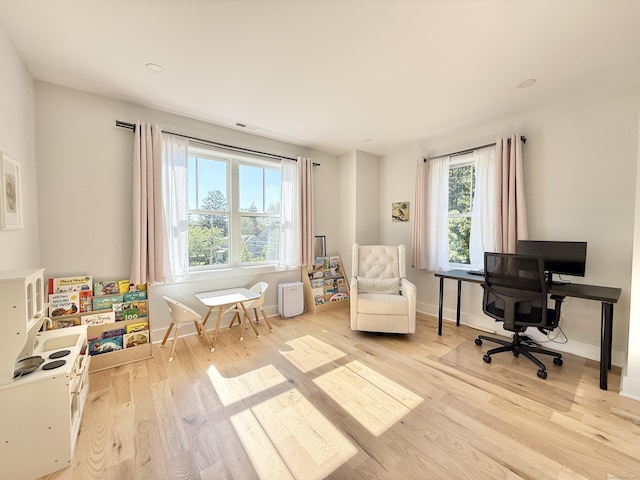 office area with light wood-style flooring and baseboards