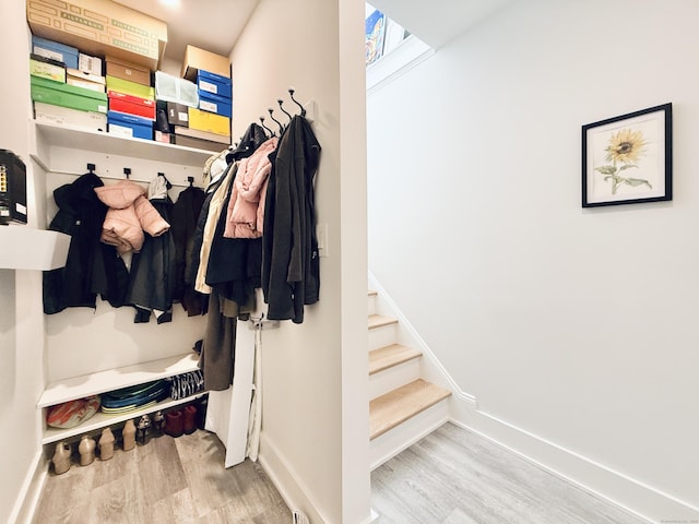 mudroom featuring wood finished floors and baseboards