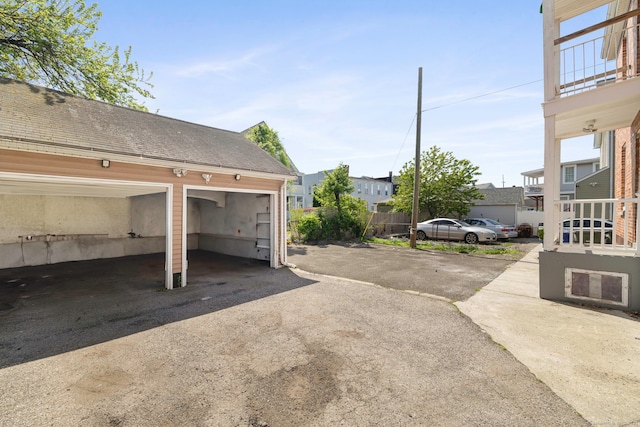 view of parking / parking lot with a garage