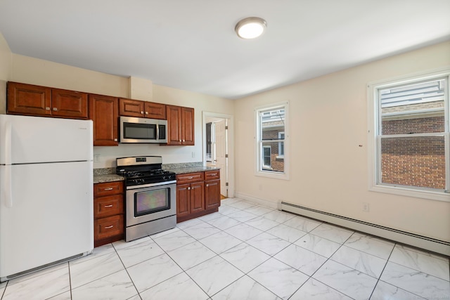 kitchen featuring appliances with stainless steel finishes, a baseboard radiator, plenty of natural light, and light stone counters