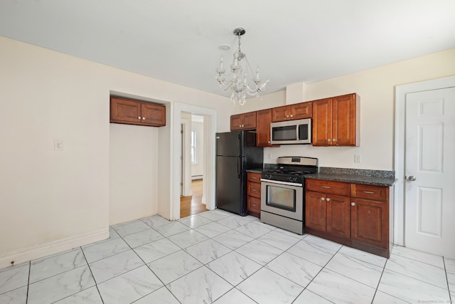 kitchen featuring appliances with stainless steel finishes, dark countertops, a chandelier, decorative light fixtures, and brown cabinets