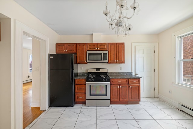 kitchen with stainless steel appliances, a baseboard radiator, a chandelier, and plenty of natural light