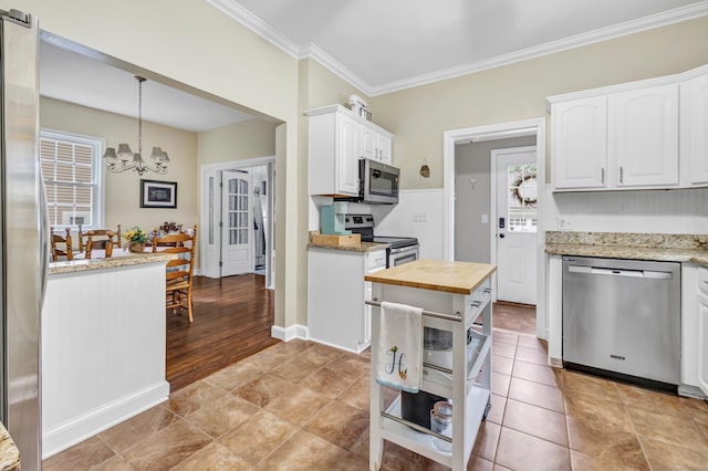 8 Thomas St, Trumbull, CT 06611 - kitchen featuring appliances with stainless steel finishes, butcher block countertops, a chandelier, ornamental molding, and white cabinetry