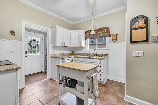 8 Thomas St, Trumbull, CT 06611 - kitchen featuring wood counters, a sink, white cabinetry, a wainscoted wall, and ornamental molding