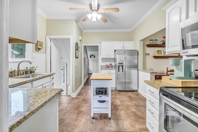 8 Thomas St, Trumbull, CT 06611 - kitchen featuring stainless steel appliances, a sink, crown molding, white cabinets, and a ceiling fan