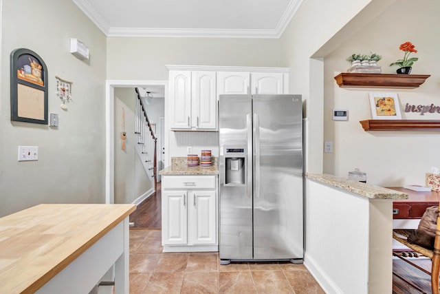 8 Thomas St, Trumbull, CT 06611 - kitchen featuring stainless steel fridge with ice dispenser, crown molding, white cabinets, light stone countertops, and light tile patterned floors