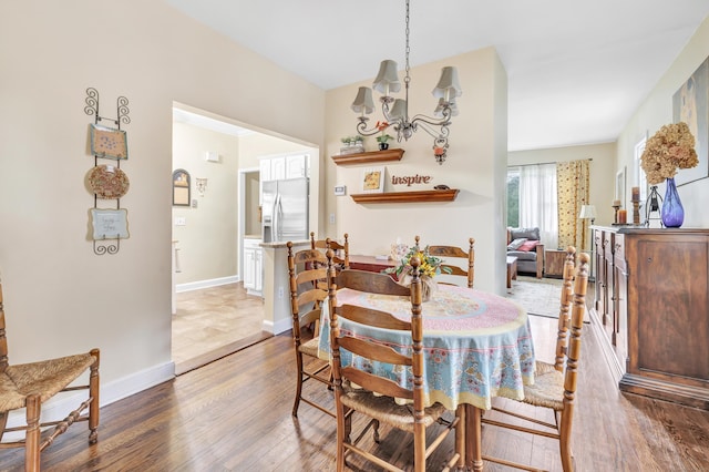 8 Thomas St, Trumbull, CT 06611 - dining space with a chandelier, wood finished floors, and baseboards