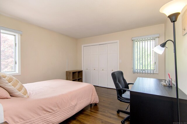 449 E Thompson Rd, Thompson, CT 06277 - bedroom with dark wood-style flooring, a closet, and a desk