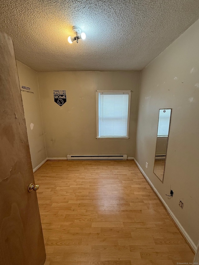 248 Lawlor St Apt 1, New Britain, CT 06051 - unfurnished room featuring a baseboard heating unit, light wood finished floors, a textured ceiling, and baseboards