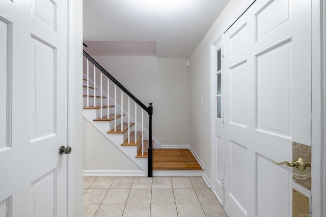 105 Reussner Rd, Southington, CT 06489 - entrance foyer with light tile patterned floors, baseboards, and stairs