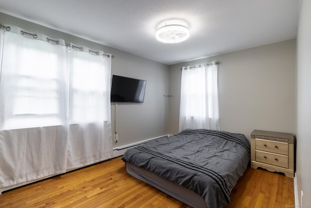 105 Reussner Rd, Southington, CT 06489 - bedroom with baseboard heating and wood finished floors