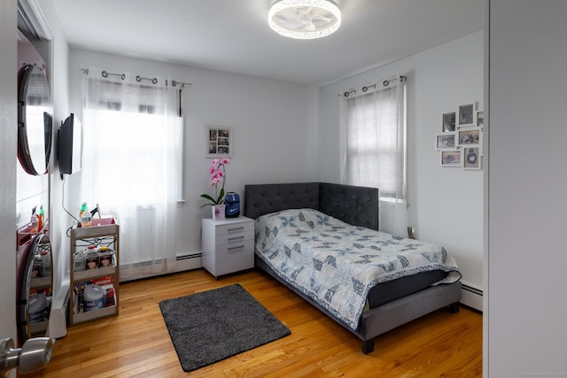 105 Reussner Rd, Southington, CT 06489 - bedroom featuring baseboard heating, multiple windows, and light wood-type flooring