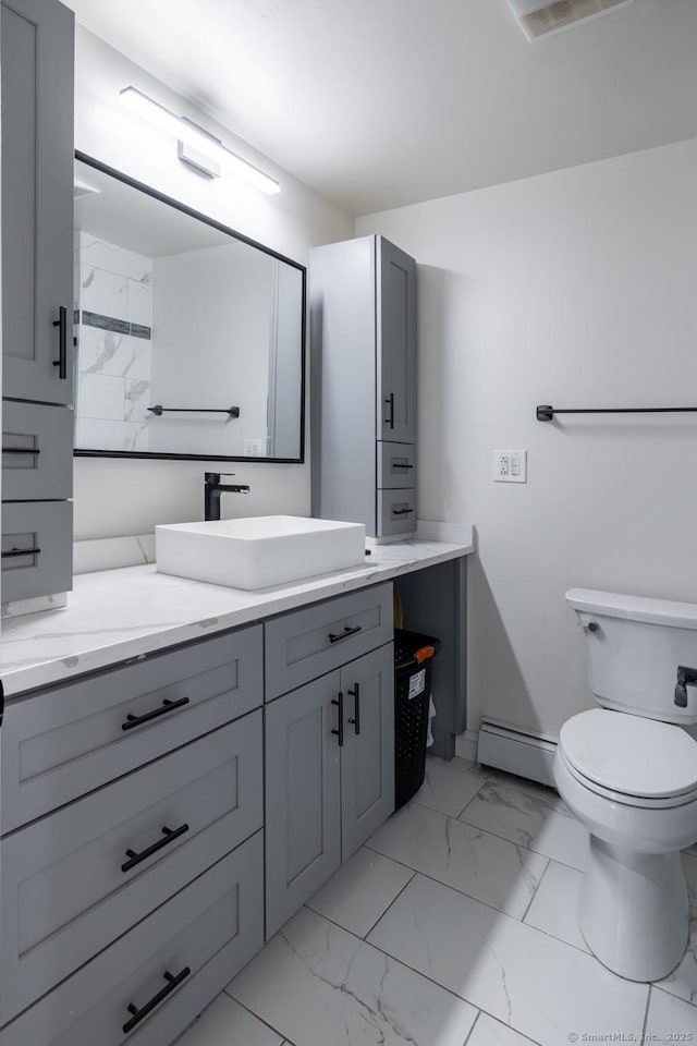 105 Reussner Rd, Southington, CT 06489 - bathroom featuring marble finish flooring, a baseboard heating unit, toilet, vanity, and baseboards