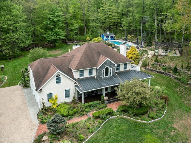 view from above of property featuring a forest and a pool