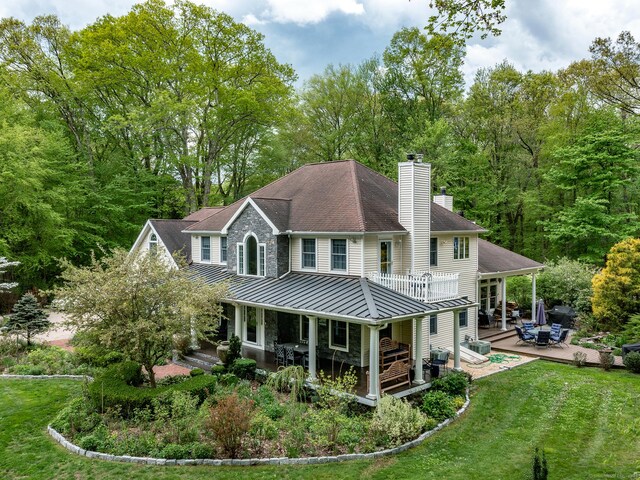 53 Transylvania Rd, Roxbury, CT 06783 - rear view of property featuring a standing seam roof, a chimney, metal roof, a lawn, and a wooden deck