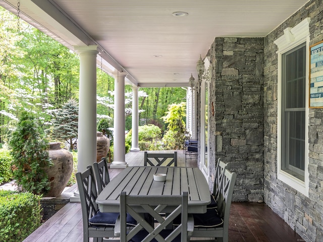 deck featuring a porch and outdoor dining area