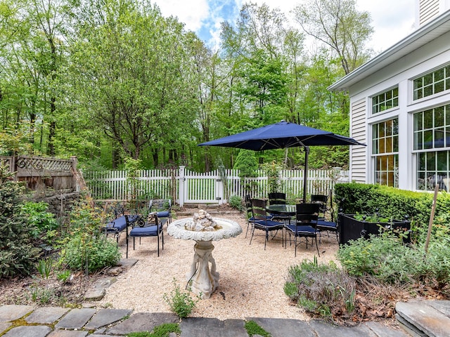 view of patio / terrace featuring fence and a fire pit