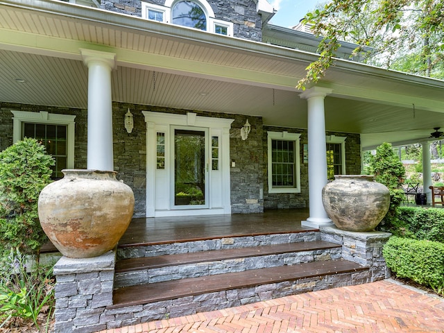 entrance to property featuring covered porch and stone siding