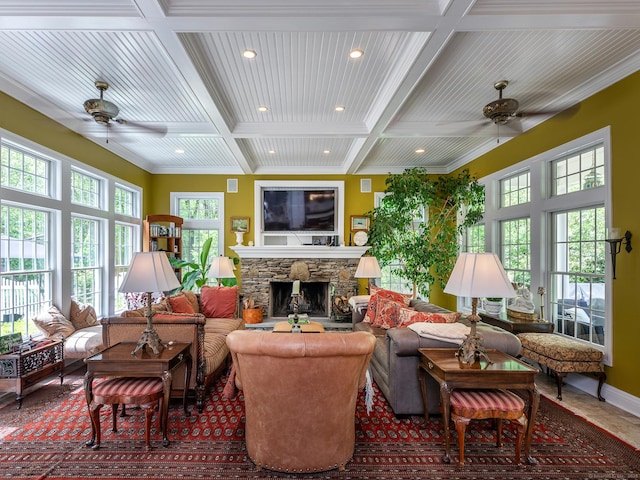 living room with a ceiling fan, coffered ceiling, recessed lighting, beamed ceiling, and a fireplace