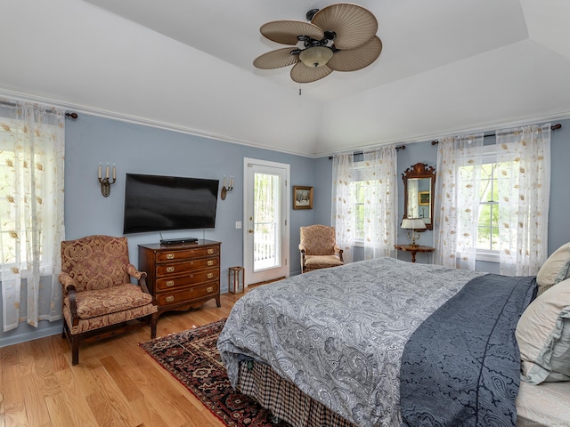 bedroom with wood finished floors, lofted ceiling, and a ceiling fan