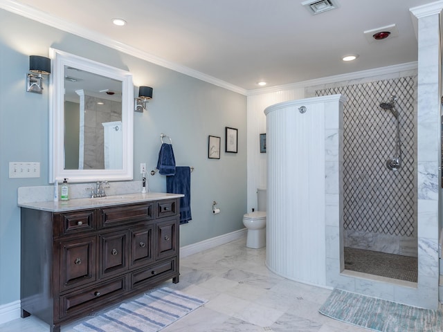 bathroom with toilet, a tile shower, ornamental molding, vanity, and baseboards