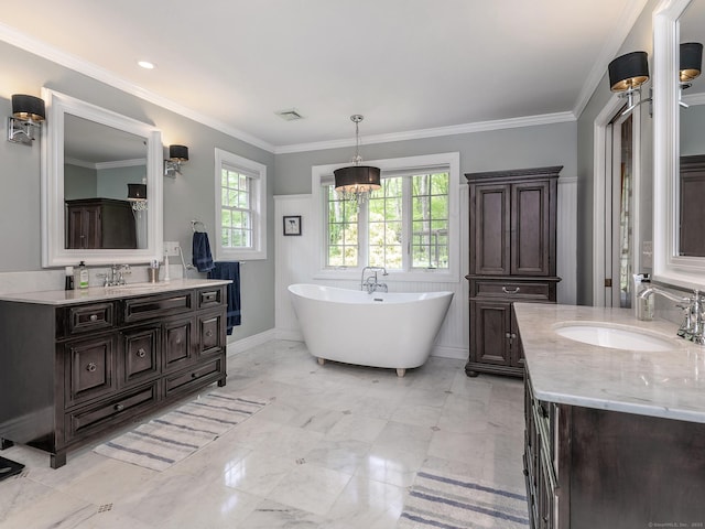 bathroom with two vanities, a freestanding bath, a chandelier, marble finish flooring, and crown molding