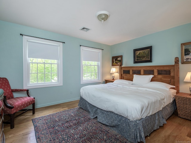 bedroom with wood finished floors and baseboards