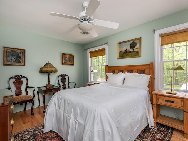 bedroom with light wood-style floors and a ceiling fan