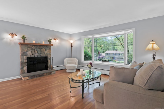 70 Bayne St, Norwalk, CT 06851 - living area with a baseboard radiator, wood finished floors, crown molding, and a fireplace