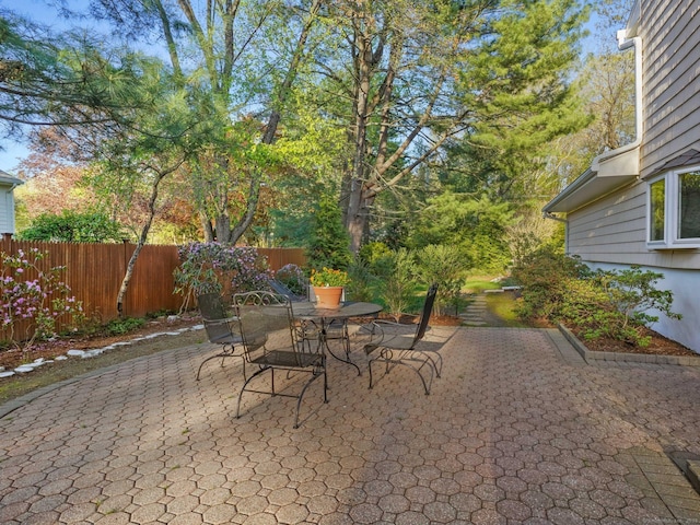 view of patio featuring fence and outdoor dining area