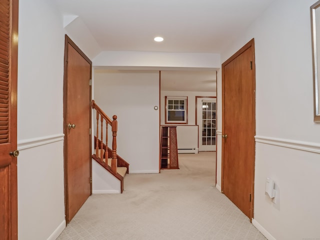 hallway featuring baseboard heating, light carpet, recessed lighting, stairway, and baseboards