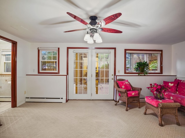 sitting room with baseboard heating, a baseboard radiator, a ceiling fan, and carpet floors